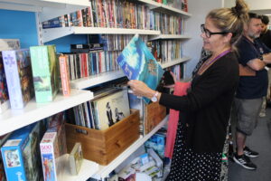 A lady with dark hair and glasses browses a selection vinyl 